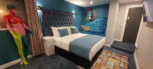 a bedroom with a bed with a blue wall at The Gate Hotel in Dublin