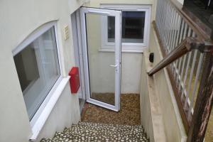 a door on a building with a window and a staircase at Willow Tree 1 bed Apartment - STAYSEEKERS in Salisbury