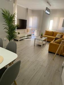 a living room with a couch and a table at Precioso apartamento a 50 metros de la playa in Melilla