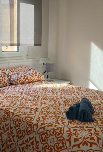 a bedroom with a large bed with blue pillows on it at Precioso apartamento a 50 metros de la playa in Melilla