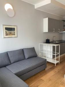 a living room with a couch and a kitchen at City Life Top apartment in Milan