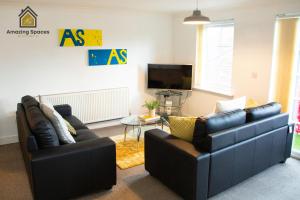 a living room with two couches and a tv at Executive 2 Bed Flat in Stockton Heath by Amazing Spaces Relocations Ltd in Warrington