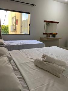 a bedroom with two beds with towels on them at Eldorado Inn in Feira de Santana