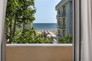 a view of the beach from the balcony of a hotel at Ariminum Hotel in Rimini