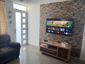 A television and/or entertainment centre at “Lucor D-Eight House” New Entire Home in the Town…