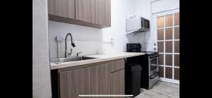 a small kitchen with a sink and a stove at 7 bedrooms in Santurce San Juan beach in San Juan