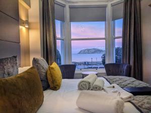 a hotel room with a bed with a large window at The Wildings Hotel & Tudno's Restaurant in Llandudno