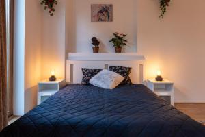 a bedroom with a bed with two lights on it at Laid Back Villa in Budapest