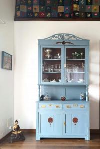 a blue hutch in a corner of a room at Breathe Nature - Beach House Azores in Feteira