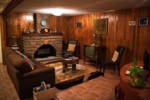 a living room with a couch and a fireplace at Posada de la Virgen in Tlaxcala de Xicohténcatl