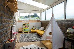 a childs play room with a couch and a tent at SAVANNAH in Saint Malo