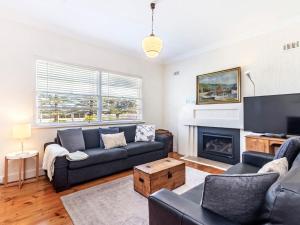 a living room with a couch and a fireplace at 40 Campbell in Port Fairy