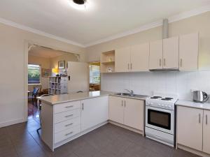 a kitchen with white cabinets and a stove top oven at 40 Campbell in Port Fairy