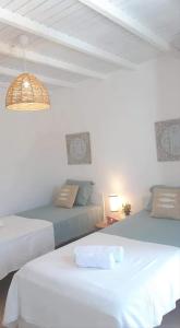 a bedroom with two beds and a couch at Cantinho de Milfontes 1 Twin in Vila Nova de Milfontes