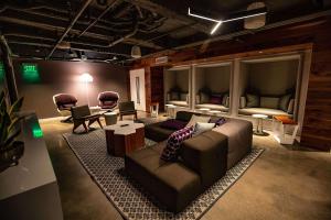a living room with a couch and chairs and a bed at Yotel San Francisco in San Francisco