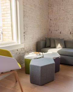 a living room with a couch and two tables at Yotel San Francisco in San Francisco