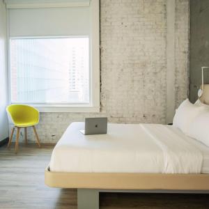 a bedroom with a bed with a laptop on it at Yotel San Francisco in San Francisco +94 photos