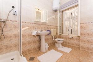 a bathroom with a sink and a shower and a toilet at Vila Liza in Trogir