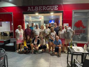 a group of people posing for a picture in front of a restaurant at Albergue Rincón del Peregrino Porriño-Pleno centro-City Center in Porriño