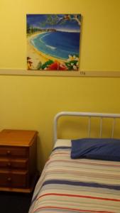 a bedroom with a bed and a desk at Gecko's Rest Budget Accommodation & Backpackers in Mackay