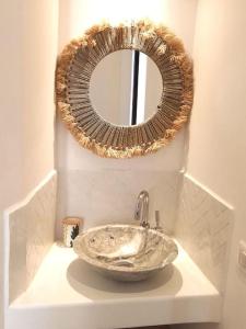 a bathroom with a bowl sink and a mirror at LaFrenchCasa Canebière in Marseille