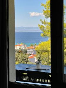 a view of the ocean from a window at Pine Resort in Polykhrono