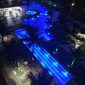 an overhead view of a swimming pool at night at PORTO MARINA MONT BLANC RESORT in Mangaratiba
