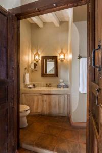 a bathroom with a toilet and a sink and a mirror at Villa Santa Mónica in San Miguel de Allende