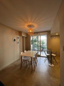 a dining room with a table and chairs and a chandelier at FIRENZE in Rosario