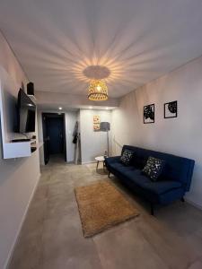 a living room with a blue couch and a ceiling at FIRENZE in Rosario