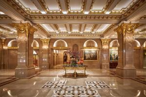 a lobby with a table with flowers on it at Lotte Hotel Seoul in Seoul +126 photos