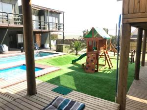 a backyard with a playground and a slide at Cabañas Arenita in Maitencillo