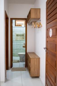 a bathroom with a toilet and a door at Acoara Beco Doce in Jericoacoara +80 photos