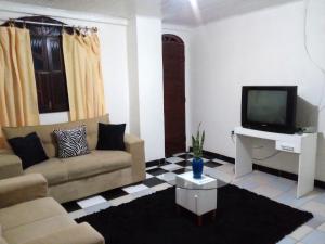 Televisyen dan/atau pusat hiburan di Soledade Pousada e Apart Hotel