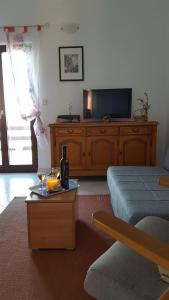 a living room with a tv and a couch and a table at Apartment Ana in Kali