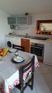 a kitchen with a table with two plates on it at Apartment Ana in Kali