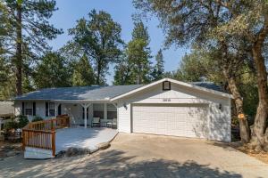 ein Haus mit einer Garage und einer Auffahrt in der Unterkunft Pine Place in Oakhurst