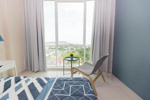 a bedroom with a bed and a chair and a window at Cozy Home with Spectacular View in Bayan Lepas +22 photos