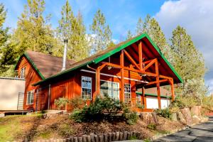 a log cabin with a green roof at Calandri Lakeview House in Bass Lake