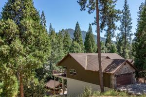 a house in the woods with trees at Iyer Lakehouse in Bass Lake