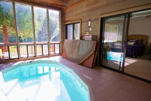 a large swimming pool in a room with windows at Yosemite Nutter Ranch in Mariposa
