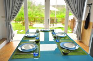 a blue and white table with plates and glasses at Sea Daughter's Homestay in Huxi