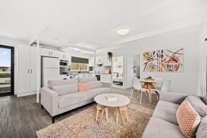 a living room with a couch and a table at The HardyOne - Aldinga Beach - C21 SouthCoast Holidays in Aldinga Beach
