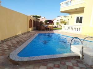 a swimming pool in the backyard of a house at Hurghada 4 bed Villa in Hurghada
