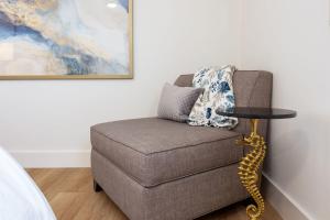 a living room with a chair and a table at Nantucket Penthouse - walk to restaurants beaches activies & so much more in Half Moon Bay +40 photos