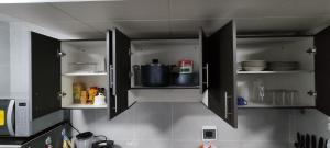 a kitchen with black cabinets with a pot in it at Edificio TERESA in La Paz