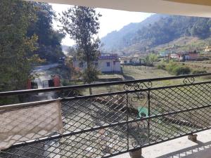 a balcony with a view of a mountain at Jungle View Home Stay in Dogadda