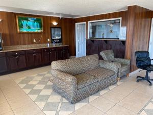 ein Wohnzimmer mit einem Sofa und einem Stuhl in der Unterkunft Luxury Inn in Montgomery