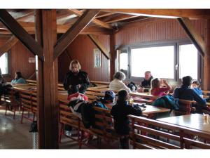 a group of people sitting in a dining room at Rifugio 2000 in Alpe Ciamporino
