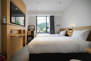 Krevet ili kreveti u jedinici u okviru objekta Henn na Hotel Seoul Myeongdong